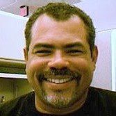 Headshot of a smiling man with a goatee.