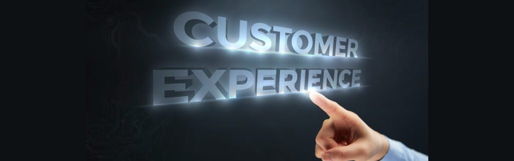 A hand pointing towards glowing "customer experience" text in a futuristic style on a dark background.