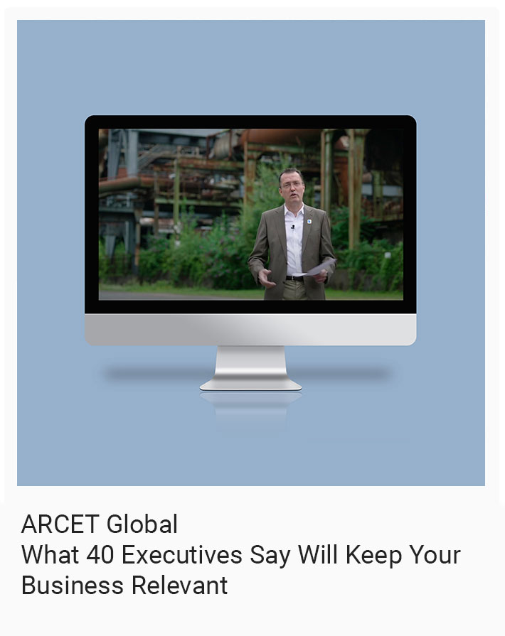 Computer monitor displaying a man speaking in front of an industrial background. Text reads: "ARCET Global: What 40 Executives Say Will Keep Your Business Relevant.